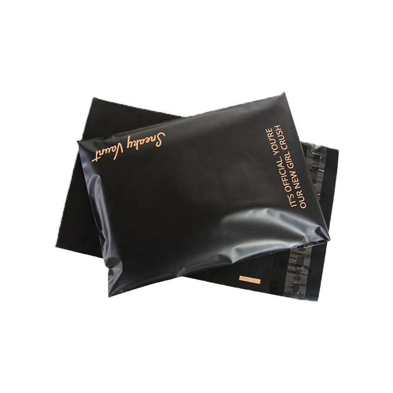 Two black plastic mailing bags with gold printed text
